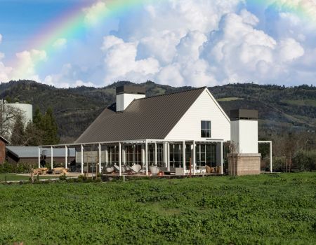 white barn-like building with lawn, fire pit, and outdoor furniture