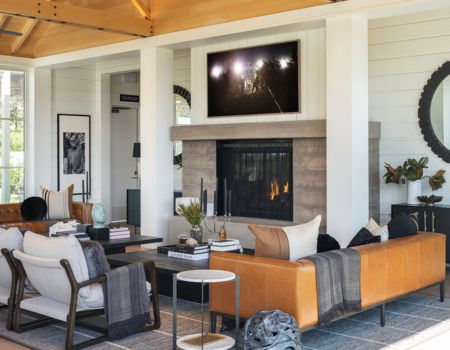 Inside Frank Family's Miller House featuring a living room-like scene with seating, a fireplace, and a tv