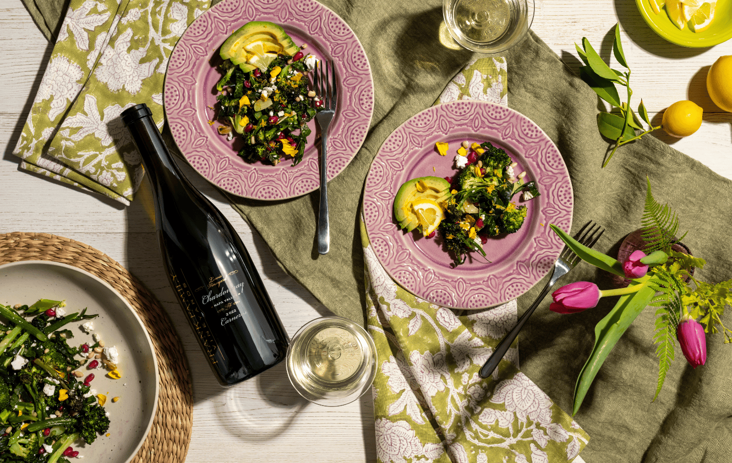 A bottle of Lewis Vineyard Chardonnay alongside a broccoli salad.