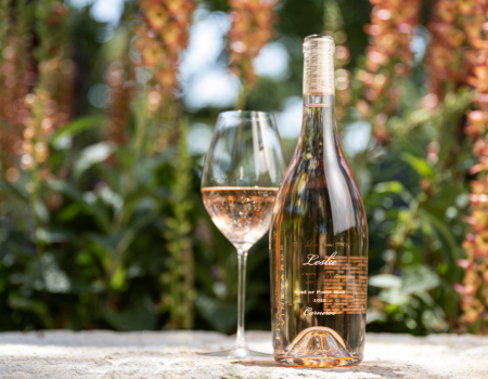 A bottle of Frank Family Leslie Rosé among pink florals. 