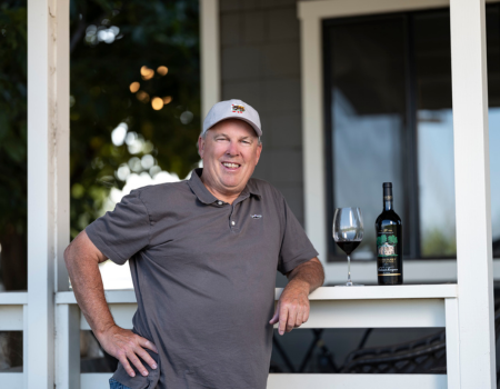 Winemaker Todd Graff poses next to a bottle of Frank Family's Napa Valley Cabernet Sauvignon