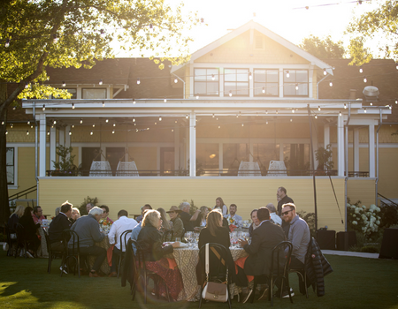 The Miller House Lawn set with tables and chair for a dinnertime event