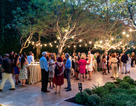 Cafe lights illuminate an evening event at the Estate Courtyard