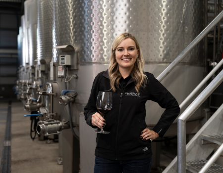 Frank Family's new winemaker Alicia Sylvester posed with a wine glass next to our wine tanks. 